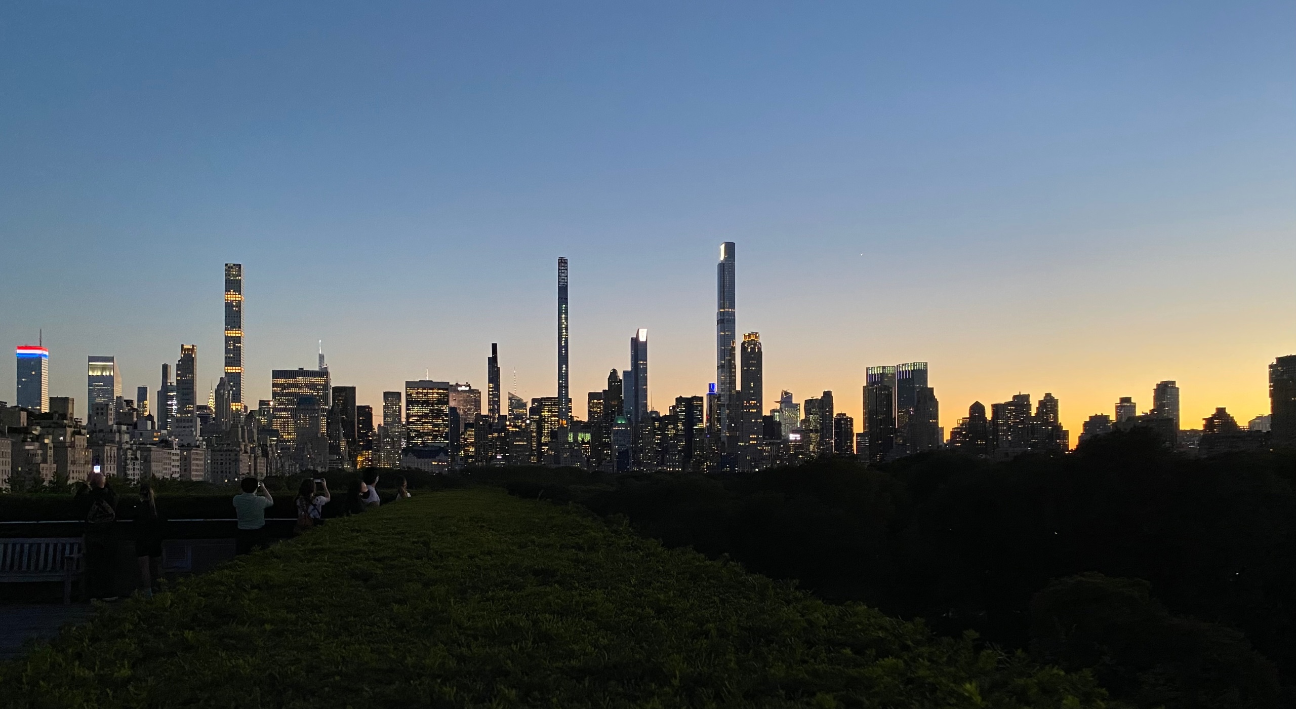 picture of New York at sunset with the Midtown skyline in the background and Central Park in the foreground